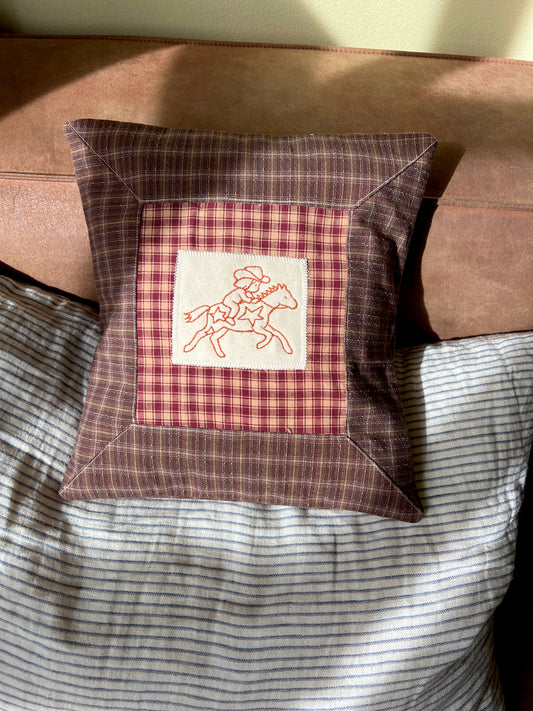 Cushion with embroidered motif
