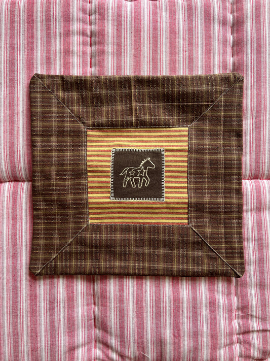 Cushion with embroidered motif