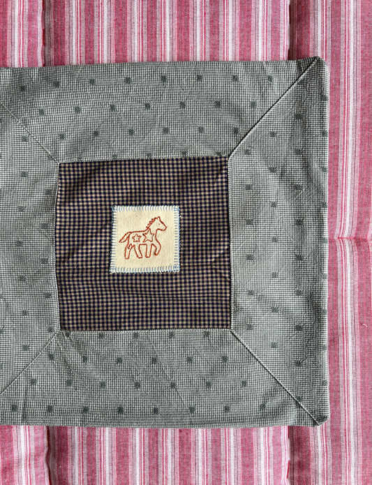 Cushion with embroidered motif