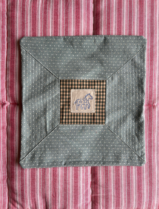 Cushion with embroidered motif